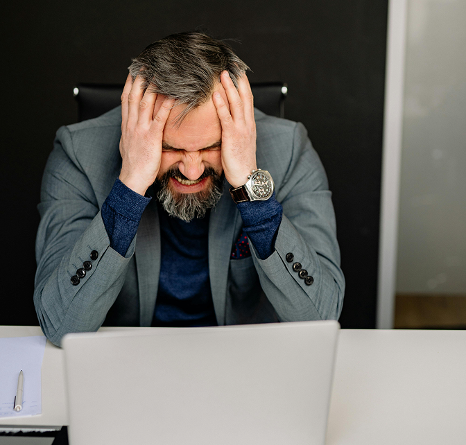 Anger 2 Man frustrated and grimacing with hands on head