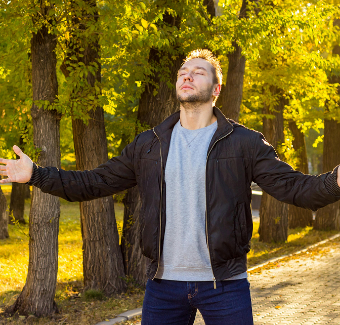 Self Esteem 4 Man standing on a walking path with his eyes closed looking up and arms spread