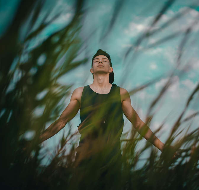 Anxiety 2 Photo of a man standing outside with his eyes closed and arms open