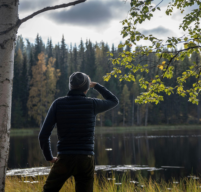 Anxiety 3 Man with a jacket and hat standing and looking over a pond